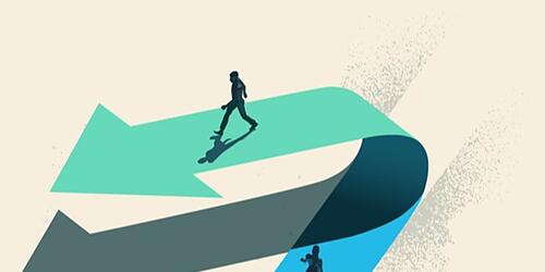 An individual choosing to walk in the opposite direction to other people on top of an arrow.